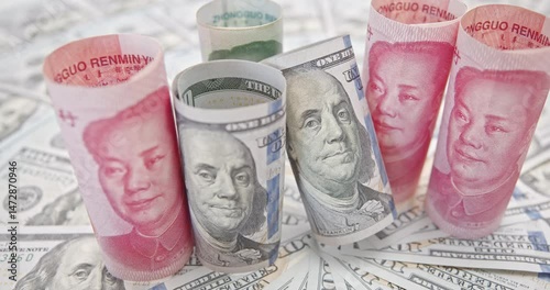 U.S.-China trade and tariffs war, currency competition : U.S. dollars and Chinese yuan highlights the ongoing global financial competition, reflecting power dynamics in trade as tensions escalate.