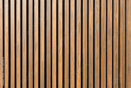 The wall is made of metal siding with imitation wooden slats