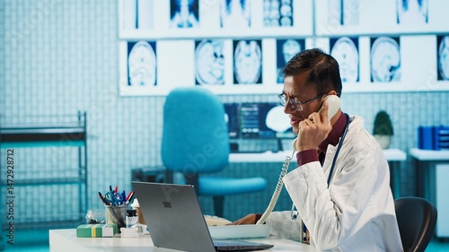 Young medical expert reviewing x ray test findings in medical office, providing a diagnosis for an ill patient. Physician studying hospital records and sharing his expertise. Camera A.