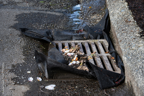 фотографія Cloth barrier in storm drain grate to prevent debris runoff from construction si