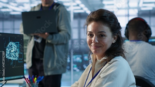 Portrait of upbeat woman working in high tech AI facility providing computing resources for different workloads. Joyous admin checking on artificial intelligence data center supercomputers, camera A
