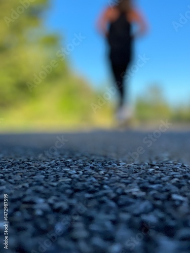 Person running on the road with a blurry background 