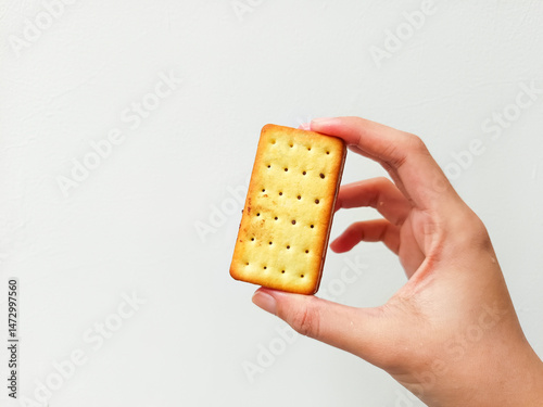 Crispy chocolate-filled biscuit with a perfect bite, held in hand—ideal for snack branding, dessert promotions, or food product advertising