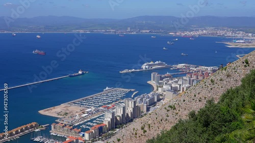 Aerial view of Gibraltar harbor, city and airport with cargo ships and cruise ships in the Strait of Gibraltar