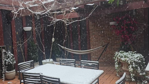 Backyard patio and table snowing landscape