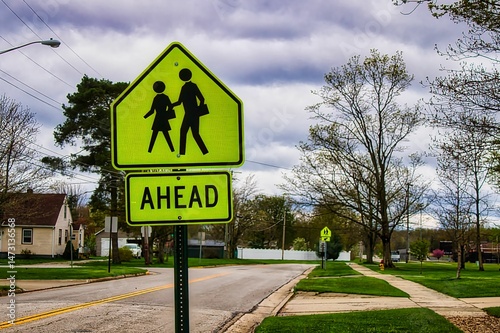 A pedestrian crossing street sign