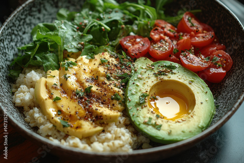 Bowl with rice, avocado, and boiled egg.