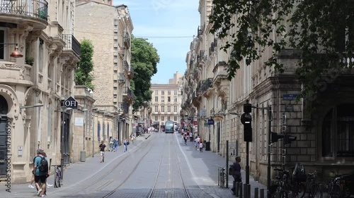 Street Of An Old European City With Pedestrians And Tram Tracks (Bordeaux, France)
