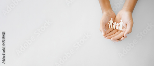 hands holding paper family cutout, foster care, homeless support, world mental health day, Autism support,homeschooling concept
