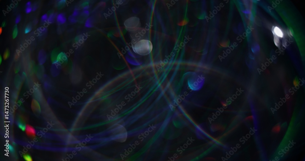 Fototapeta premium Lens flare. Blurred garland. Defocused blue green sparks multicolored radiance bokeh light abstract background.