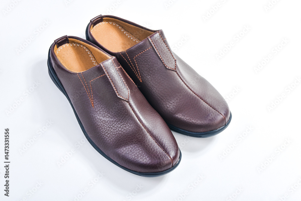 Brown leather slippers isolated on white background Brown leather slippers isolated on white background
