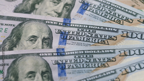 Closeup view of United States Hundred Dollar Bills, highlighting their designs and intricacies