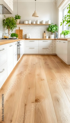 A modern kitchen with white cabinets, a wooden countertop, and a wooden floor