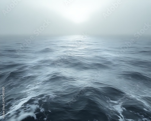 Misty ocean, sunlit horizon.
