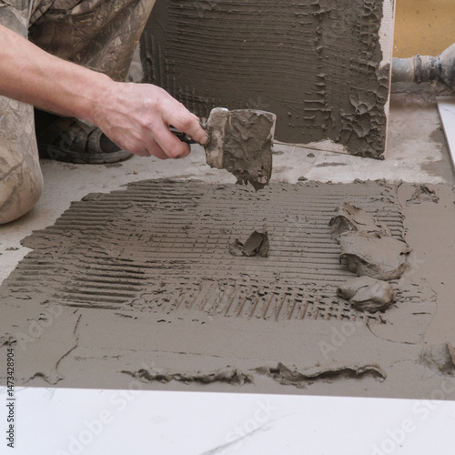 Hand Applying Tile Adhesive for Flooring Installation