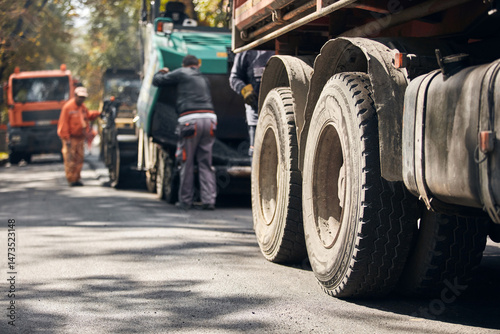 Heavy construction machines and truck outdoors for public street works.