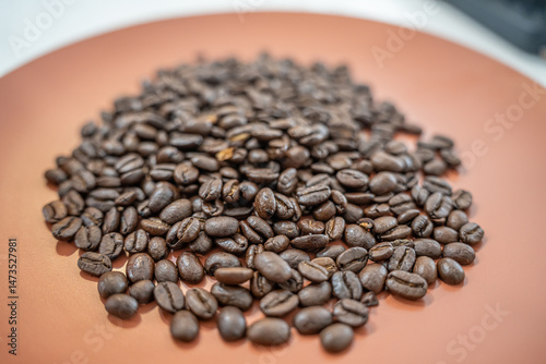 Fresh organic raw coffee beans on a plate