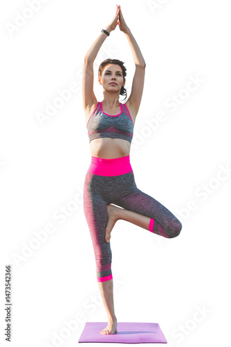 Fit woman practicing tree pose on yoga mat with hands raised above head, wearing pink and gray sportswear, healthy lifestyle and balance training concept, full-length view, isolated on white backgrou