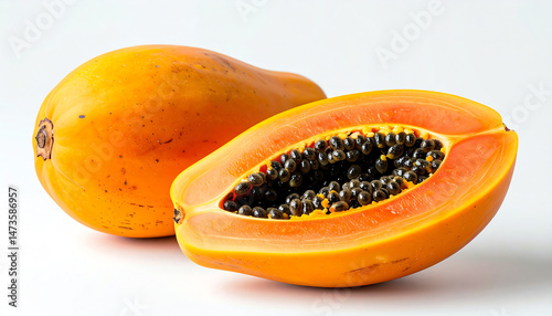 A vibrant papaya, showcasing its bright orange flesh and black seeds, rests beside its whole counterpart on a clean, white background