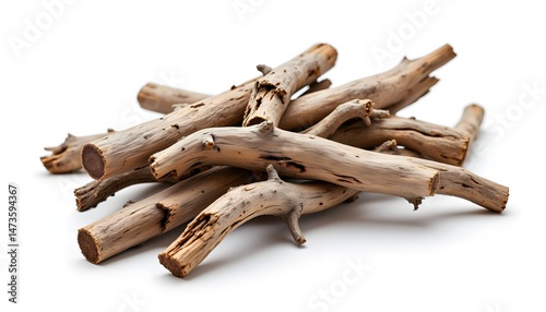 A bundle of weathered tree limbs, stripped of leaves and bark, gathered together against a stark white backdrop