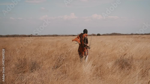 Masai Warrior Throwing Spear in African Savannah