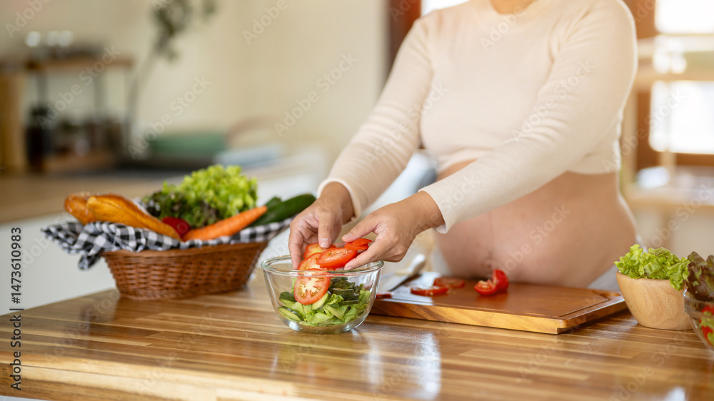 Pregnant Asian woman cooking healthy food at home Pregnant Asian woman cooking healthy food at home