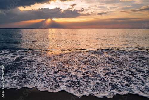Sunset on the beach with waves.