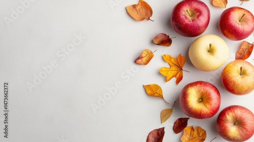 Flat lay of six red apples and a yellow apple on a white background. the apples are arranged in a scattered manner, with some overlapping each other.
