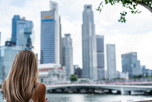 Photography Businesswoman admiring singapore skyline: modern architecture and urban developm