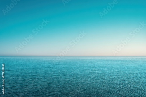 Wallpaper Mural Expansive view of a tranquil ocean meeting a clear, vibrant sky.  A flat horizon separates the deep blue water from the pale, soft blue of the sky, creating a sense of vastness and calmness Torontodigital.ca