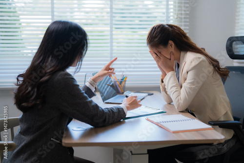 Картината върху платно Businesswoman scolding her distressed colleague, who is covering his face with h