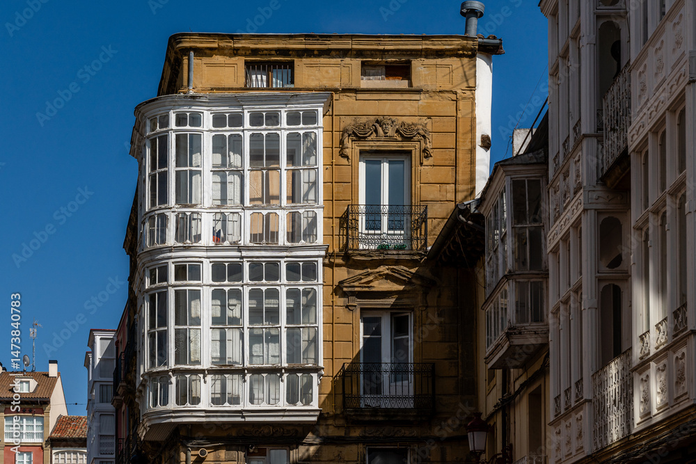 Fototapeta premium Sunlit Historic Building with Traditional Balconies and Stone Facade in Haro, La Rioja, Spain