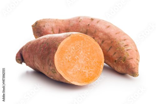 Raw sweet potatoes isolated on white background..