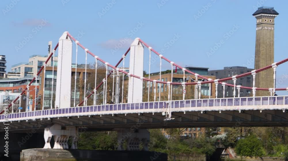 Chelsea Bridge in London, UK, with a red bus passing on a clear sunny day