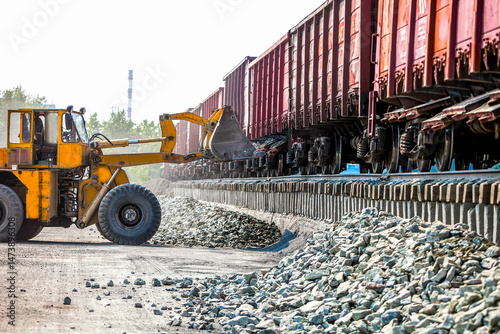 Yellow bulldozer working in quarry