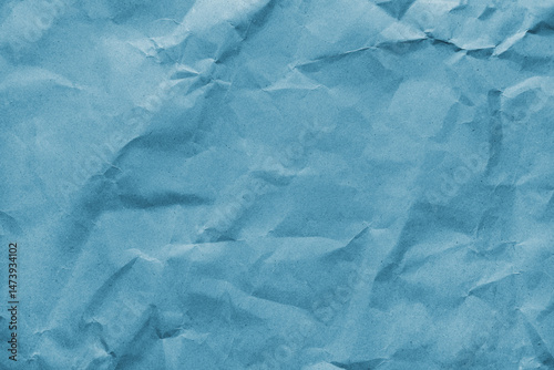 Recycled crumpled blue colored paper texture. Wrinkled craft paper background, rough cardboard surface, wallpaper, backdrop. Design element, copy space for text