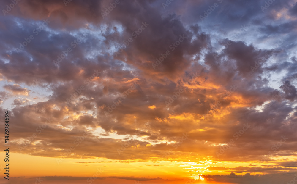 A vibrant sunset sky with orange and red colors as a background or texture A vibrant sunset sky with orange and red colors as a background or texture