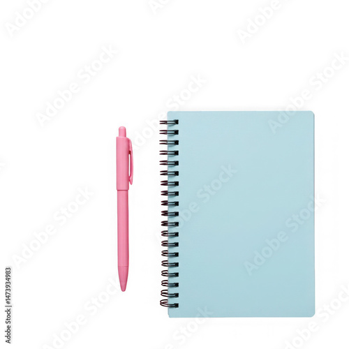 Top view of a light blue notebook with a pink pen on a black background flatlay