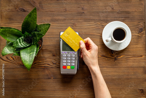 Paying a bill for a coffee at a cafe - bank payment terminal for payment by credit cards