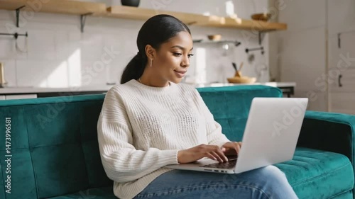 Smiling businesswoman using a laptop for online work at home