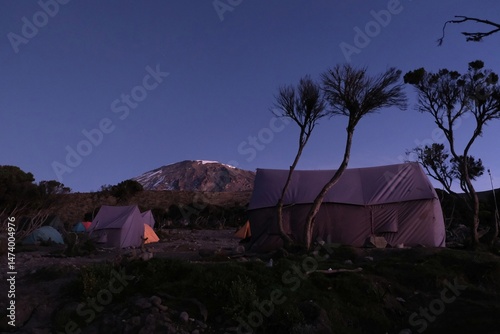 Obraz na płótnie Mweka Camp on Kilimanjaro, Tanzania with tents on camp and Kilimanjaro peak in background. w salonie