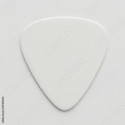 A plain white guitar pick isolated on white
