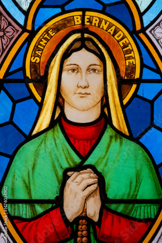 Fotografie Stained glass (1939) of St Bernadette Soubirous, visionary of the apparitions of the Virgin Mary in Lourdes