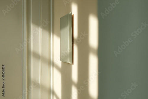 minimalist composition featuring mirror shifted to right surrounded by ample negative space on left