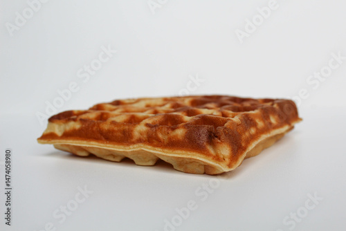 One plain square waffle cake, burnt side, isolated on white background