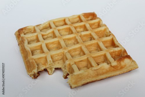 One bitten waffle cake, isolated on white background