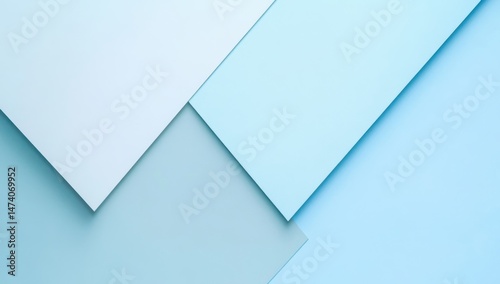 Abstract geometric design with overlapping light blue and gray paper shapes.  Layered, cool tones, creating a soft, contemporary aesthetic