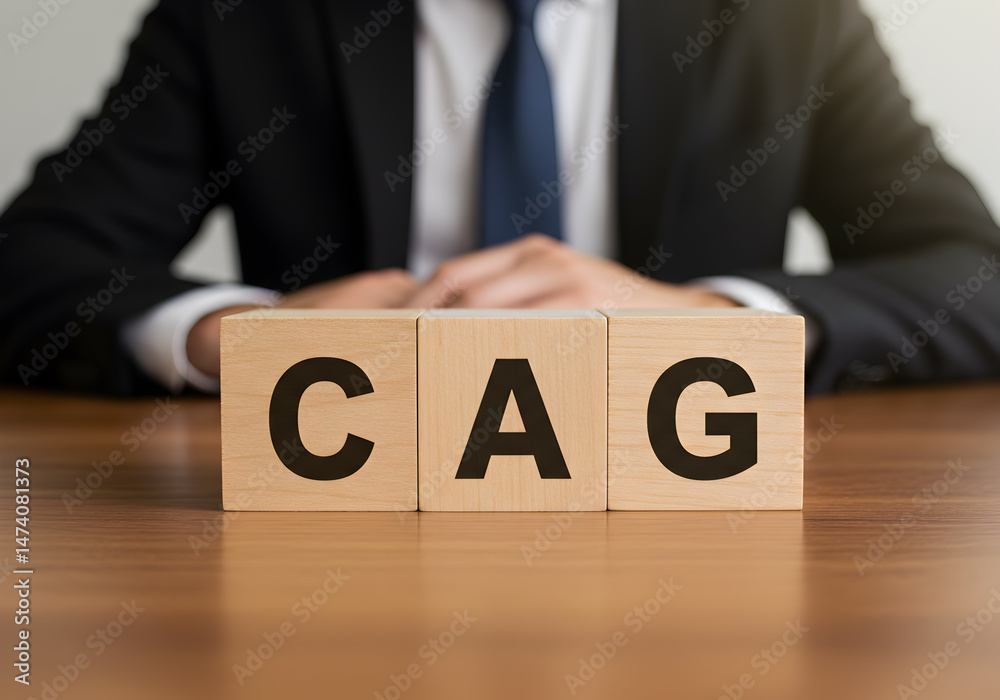 Naklejka premium Understanding cag cost per acquired customer with business man in suit and wooden blocks on table
