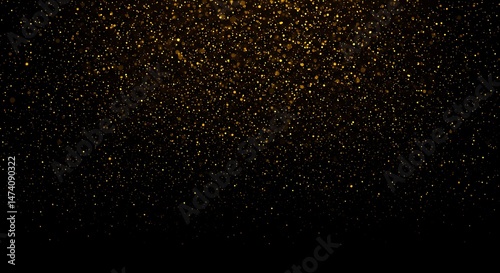 Golden glitter sparkles falling on black background for festive backdrop
