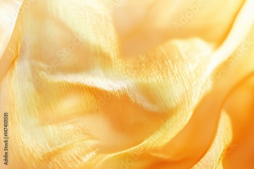 Soft, flowing, golden fabric drapes in subtle color variations.  Texture shows subtle ripples and folds